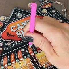 Applying gems to Halloween candy shop craft